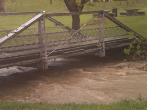 Flooding under a wooden bridge