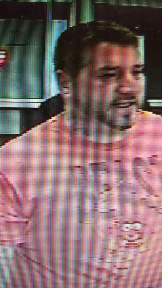 Close-up of man in security camera image with beard and red Beast Mode shirt